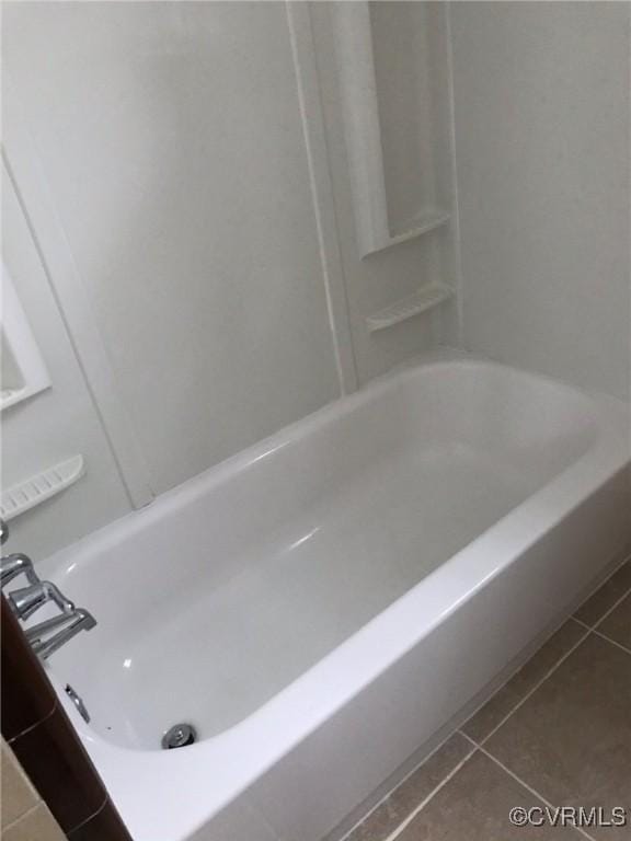full bath with tile patterned flooring and a washtub