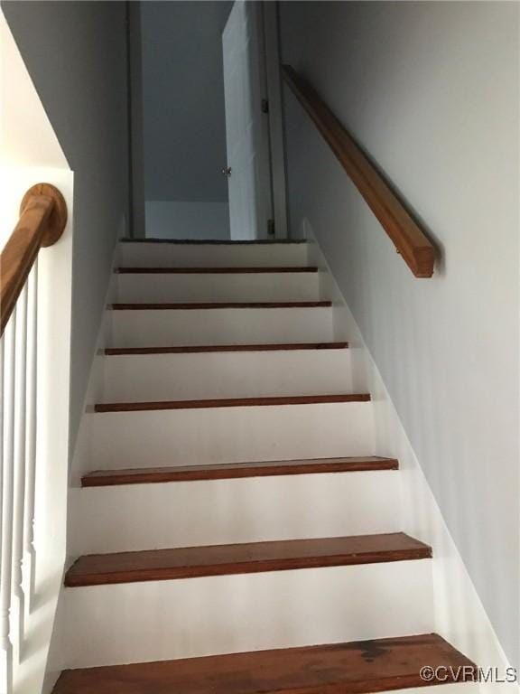 stairway with wood finished floors