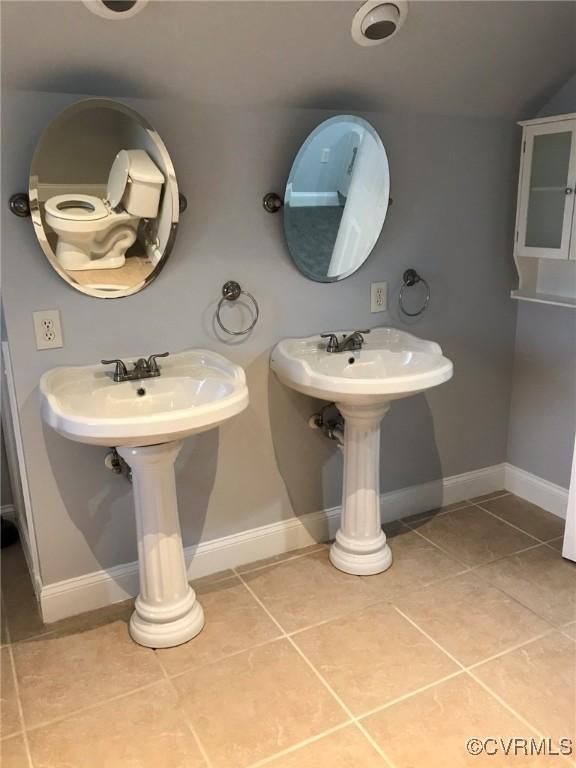 bathroom with tile patterned floors and baseboards