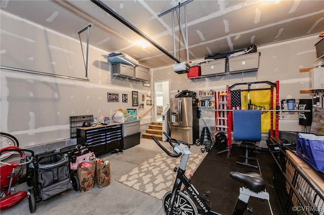 7585 Sedge Dr, New Kent, VA 23124 - garage featuring stainless steel refrigerator with ice dispenser and a garage door opener