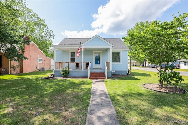 bungalow-style house with a porch, a shingled roof, a front yard, and cooling unit