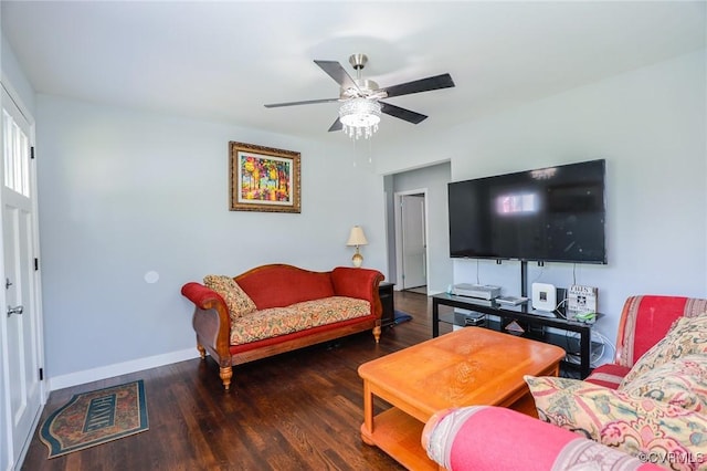 living room with baseboards, a ceiling fan, and wood finished floors