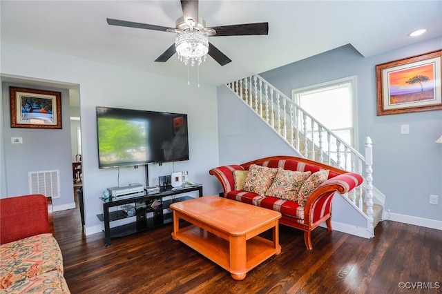 living area with a ceiling fan, baseboards, wood finished floors, visible vents, and stairway