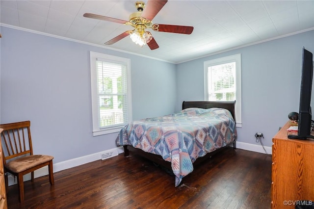 bedroom featuring crown molding, a ceiling fan, baseboards, visible vents, and hardwood / wood-style flooring