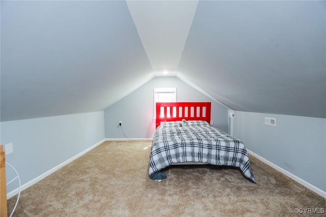 bedroom with visible vents, baseboards, carpet, and lofted ceiling