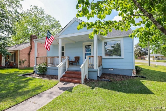 bungalow-style house featuring a front yard, roof with shingles, covered porch, and crawl space