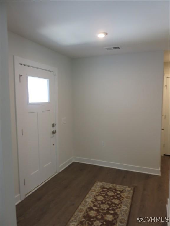 entrance foyer with baseboards, dark wood-style floors, and visible vents