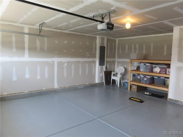 garage with a garage door opener and electric panel