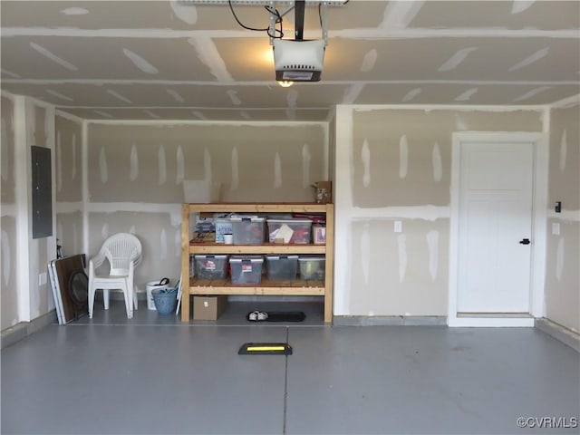 garage with a garage door opener and electric panel
