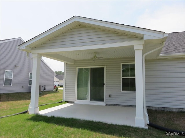 back of property featuring a shingled roof, ceiling fan, a yard, and a patio area
