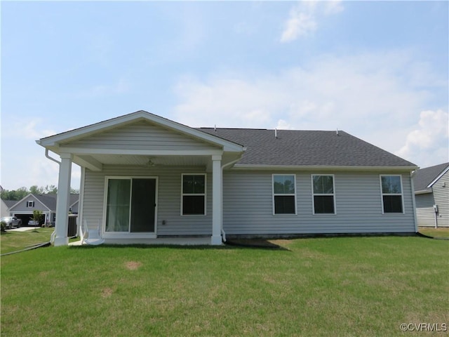 rear view of house featuring a lawn