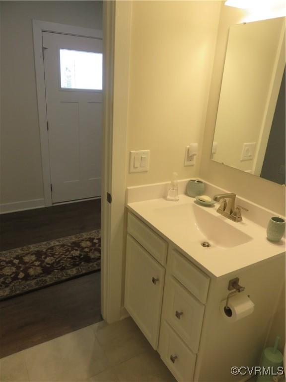 bathroom with vanity and wood finished floors