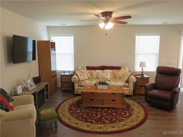 living room featuring visible vents, ceiling fan, and wood finished floors
