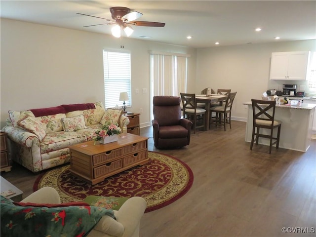living area with baseboards, recessed lighting, ceiling fan, and wood finished floors