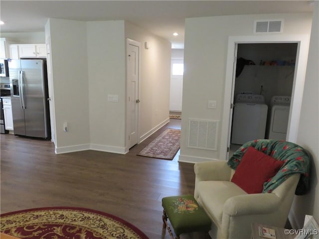 interior space with visible vents, recessed lighting, dark wood-type flooring, and washing machine and dryer