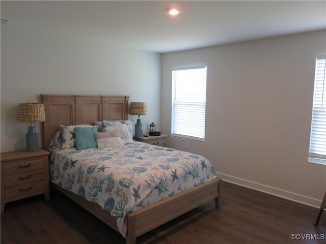 bedroom with baseboards and dark wood-style floors