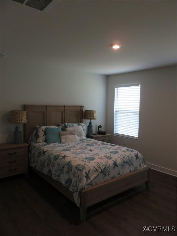 bedroom with recessed lighting, baseboards, visible vents, and dark wood-style floors