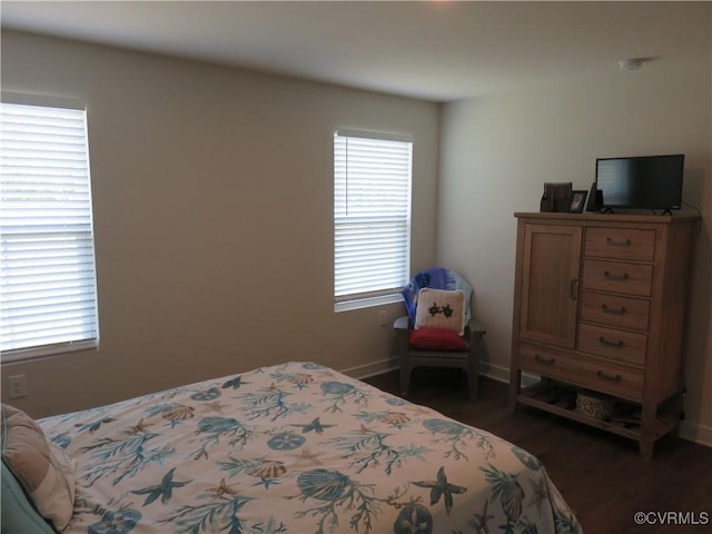 bedroom featuring baseboards and wood finished floors