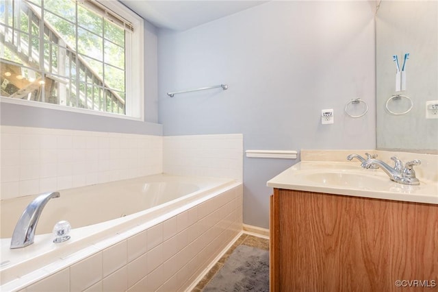 608 Southampton Dr, Ruther Glen, VA 22546 - bathroom featuring vanity, a garden tub, baseboards, and tile patterned flooring