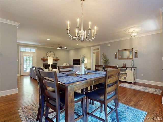 dining space featuring baseboards, crown molding, and wood finished floors