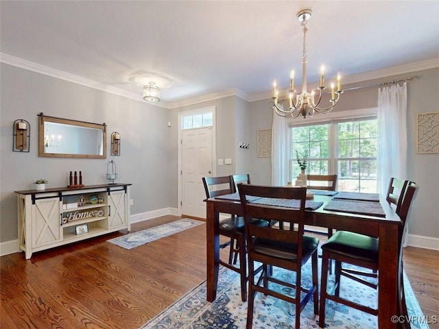 dining space with an inviting chandelier, ornamental molding, baseboards, and wood finished floors