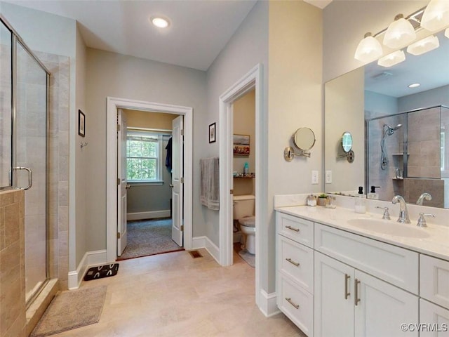 bathroom with vanity, toilet, and a shower stall