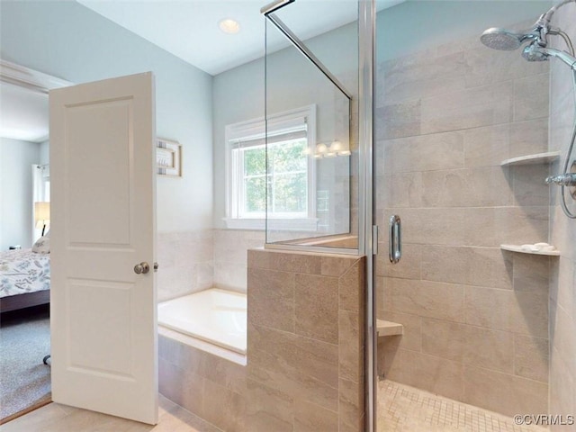 full bath with tile patterned flooring, a shower stall, a bath, and connected bathroom