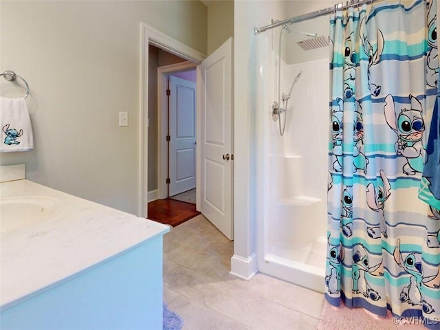 bathroom featuring vanity and a stall shower