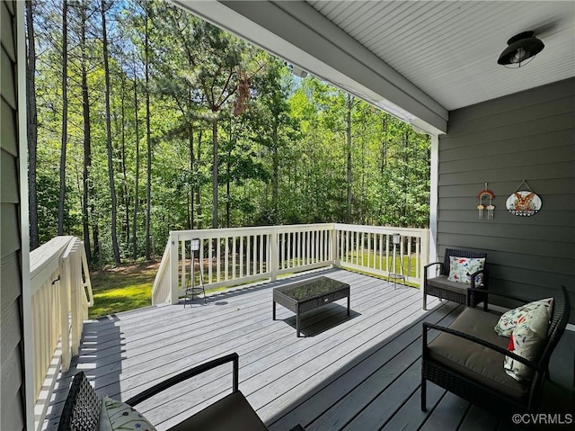 wooden terrace with a wooded view