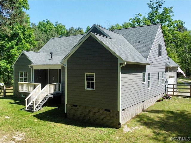 rear view of property with fence, roof with shingles, stairway, crawl space, and a yard