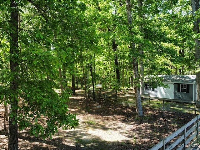 view of yard featuring a storage shed and an outbuilding