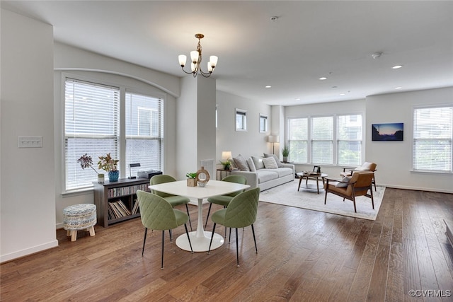 dining area with recessed lighting, baseboards, a chandelier, and hardwood / wood-style floors