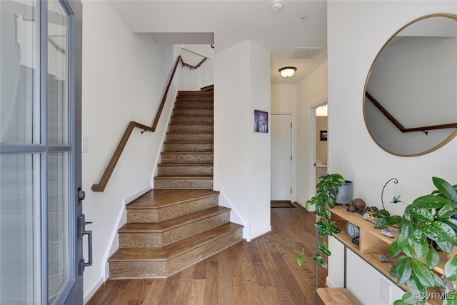 stairs with baseboards and wood finished floors