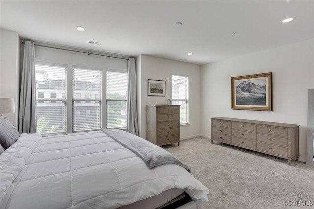 carpeted bedroom featuring baseboards, recessed lighting, and visible vents