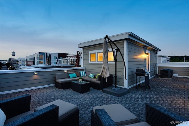 rear view of property with a patio, an outdoor living space, and central AC unit