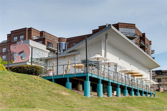 rear view of property featuring a lawn