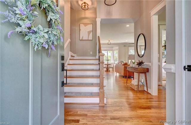 foyer entrance featuring stairway, recessed lighting, and wood finished floors
