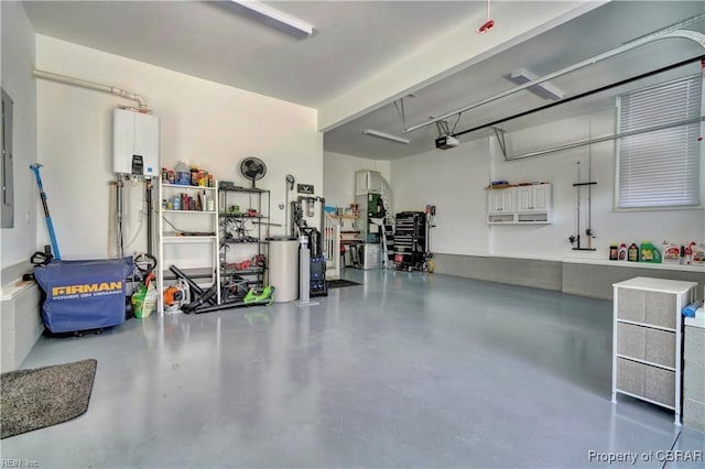 garage with tankless water heater and a garage door opener