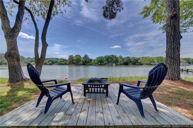 wooden deck featuring a water view and an outdoor fire pit