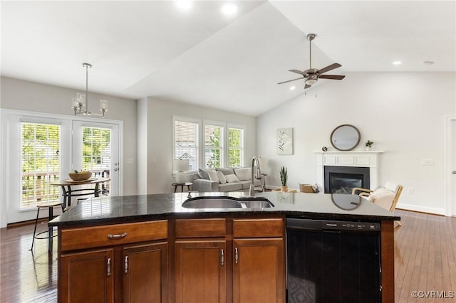 kitchen with a sink, dishwasher, a wealth of natural light, and open floor plan