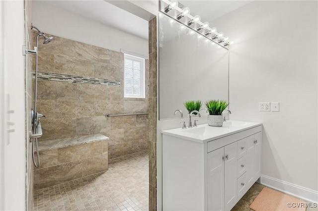 full bathroom with double vanity, a walk in shower, and a sink