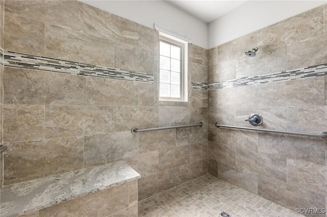 bathroom with a tile shower