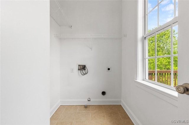 laundry area with electric dryer hookup, hookup for a washing machine, baseboards, and laundry area