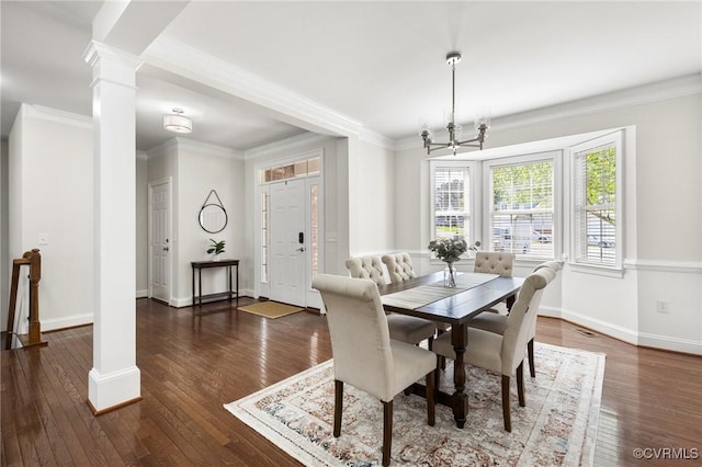 dining space with ornate columns, baseboards, and hardwood / wood-style flooring