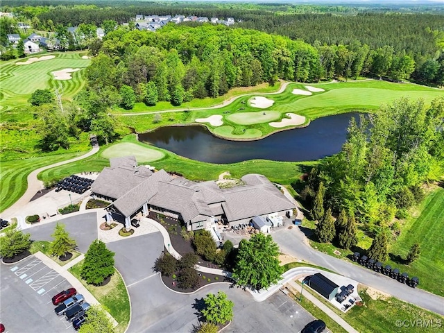 birds eye view of property featuring a water view, view of golf course, and a wooded view
