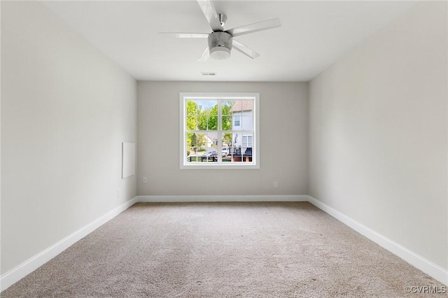carpeted empty room featuring a ceiling fan, baseboards, and visible vents