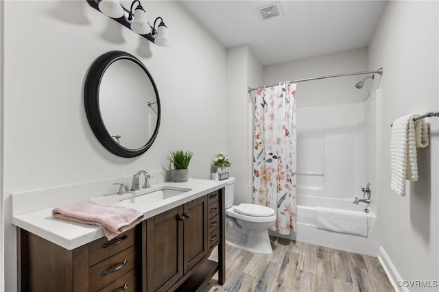 full bath with vanity, toilet, shower / bath combination with curtain, wood finished floors, and visible vents