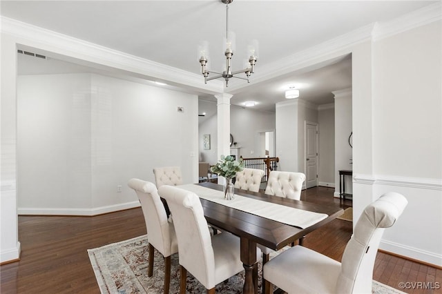 dining space featuring baseboards, ornamental molding, and wood finished floors