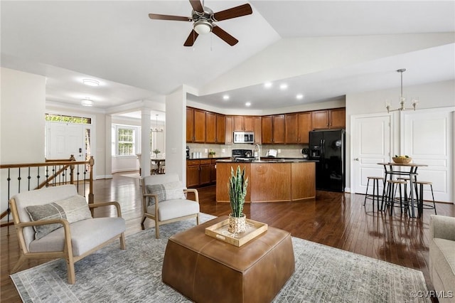 living room with vaulted ceiling, recessed lighting, a ceiling fan, and dark wood-style flooring