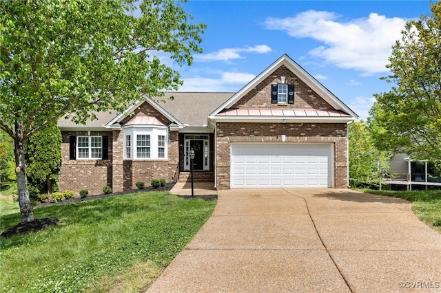 craftsman house with brick siding, driveway, and a front lawn